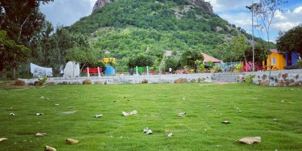 Scenic gathering spot at Namooru Ecostay overlooking a majestic hill.