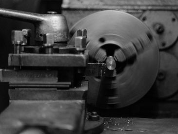 Representative stock photograph of metal turning on a lathe.