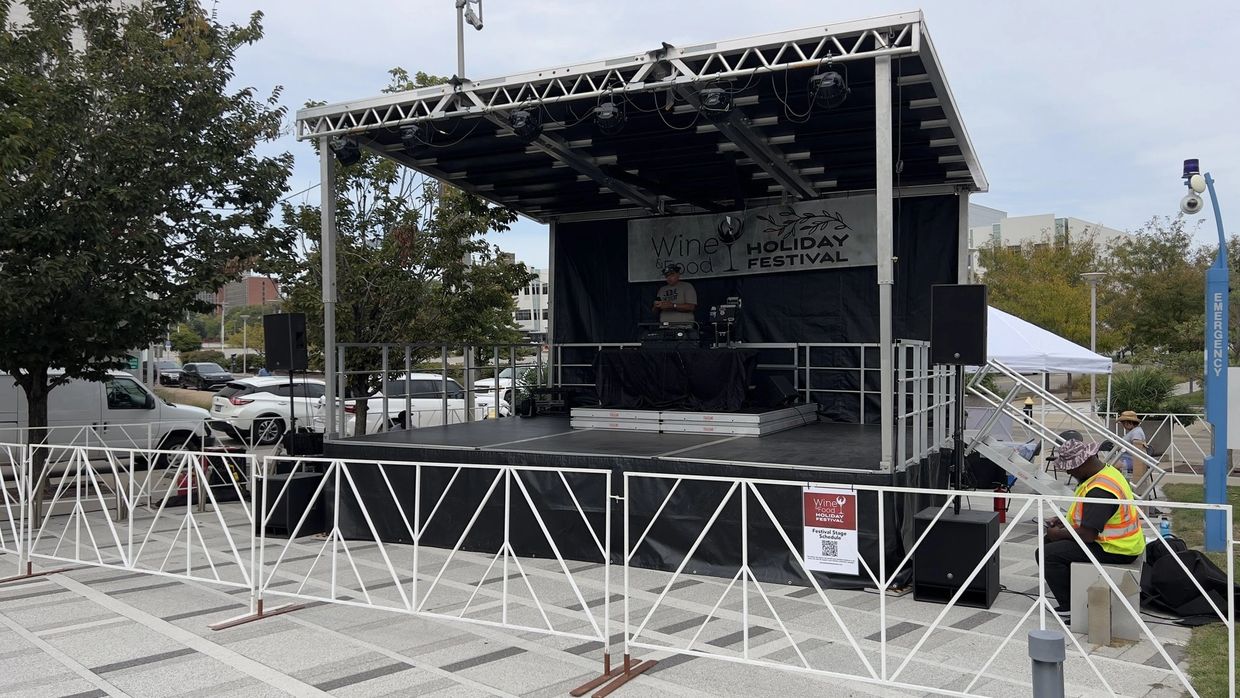 Stageline SL75 mobile stage with barricade, stairs & DJ setup at outdoor festival, Complex Sound AV