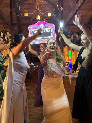 Bride joyfully celebrating with friends at her wedding reception.