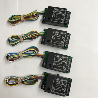 Several new 7-way bypass relays with wires neatly tied, on a clear white background.
