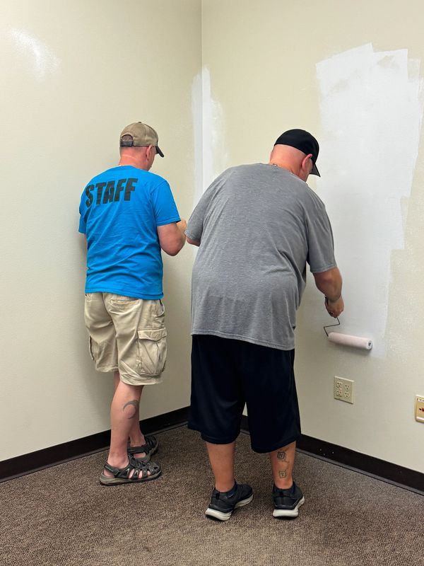 WM and The Secretary roll up their sleeves and prime the walls for a coat of paint.