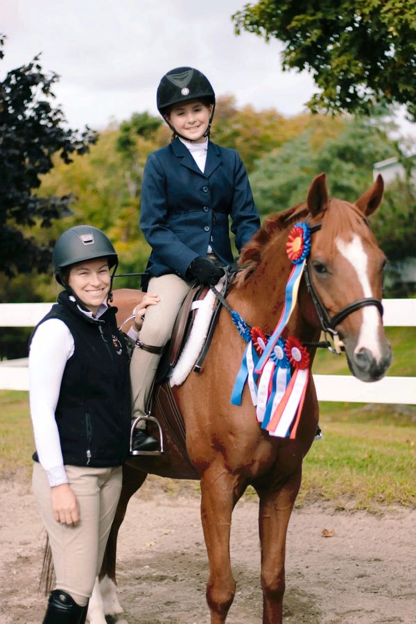 grand champion lots of blue ribbons at a horse show for a beginner rider in cross rails