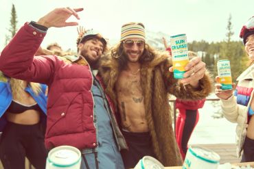 Group enjoying drinks outdoors in winter.