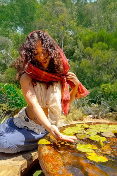 Woman relaxing in sunlight, embracing holistic wellness.
