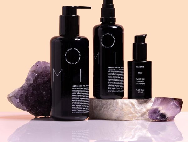 Black hair treatment bottles with amethyst crystals.