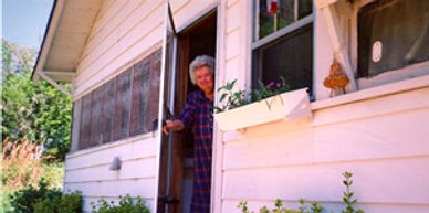My mother, at the back door of the old farm house back  home