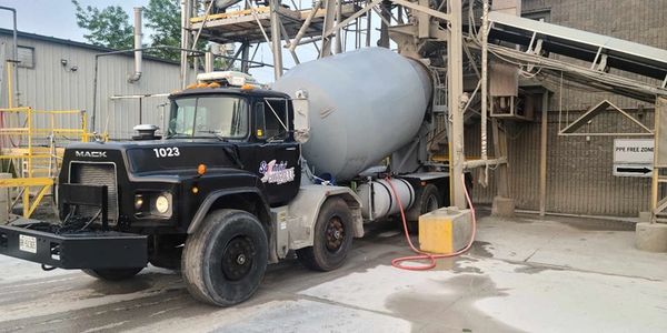 Ready mix truck picking up load at a plant.