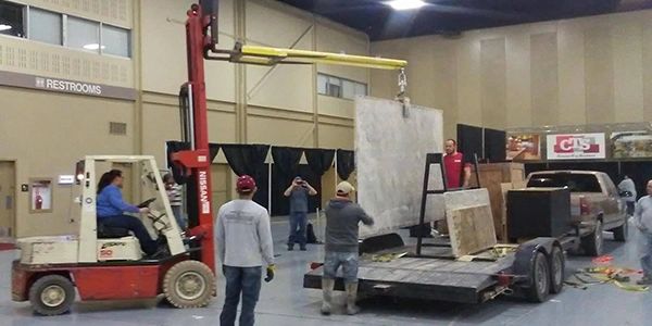 Forklift Service placing large stone slabs at the Tulsa Remodel & Landscape Show