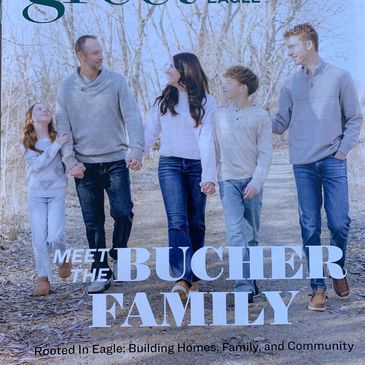The Bucher family walking outdoors, holding hands and smiling.