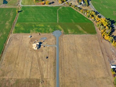 Aerial view of a single house and empty lots.