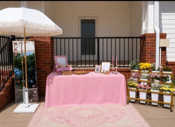 A pastel-themed outdoor table setup with bloom cart