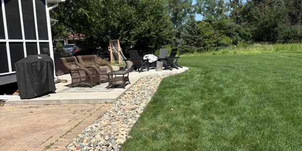 River Rock Install along paver patio by HammerTime Landscaping LLC in Lake Elmo, MN.