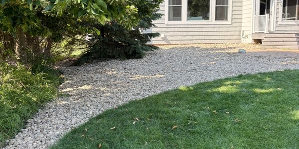 River Rock Install by HammerTime Landscaping LLC in Lake Elmo, MN.