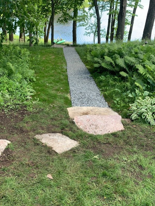 Stone walkway and gravel path by HammerTime Landscaping LLC in Stillwater, MN.