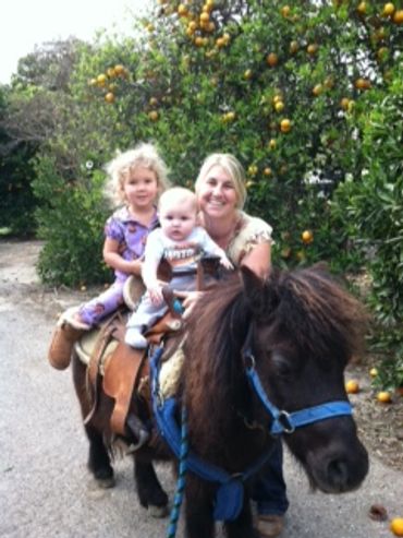 Tawni Angel and her kids riding a pony