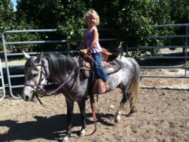 Tawni's daughter riding a pony