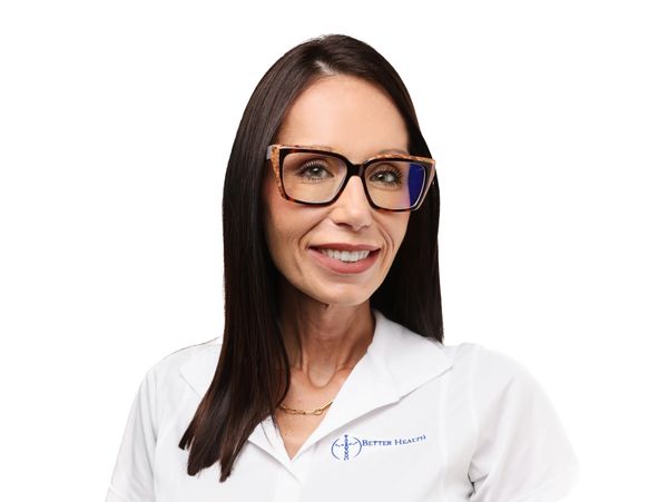 Smiling woman with glasses in a white health uniform.