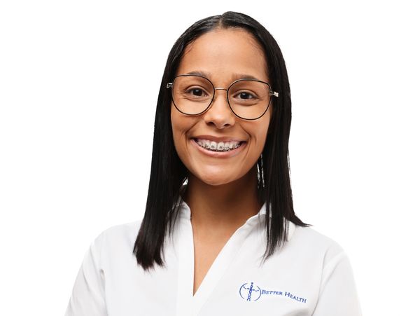 Smiling woman wearing glasses and braces in a white lab coat.