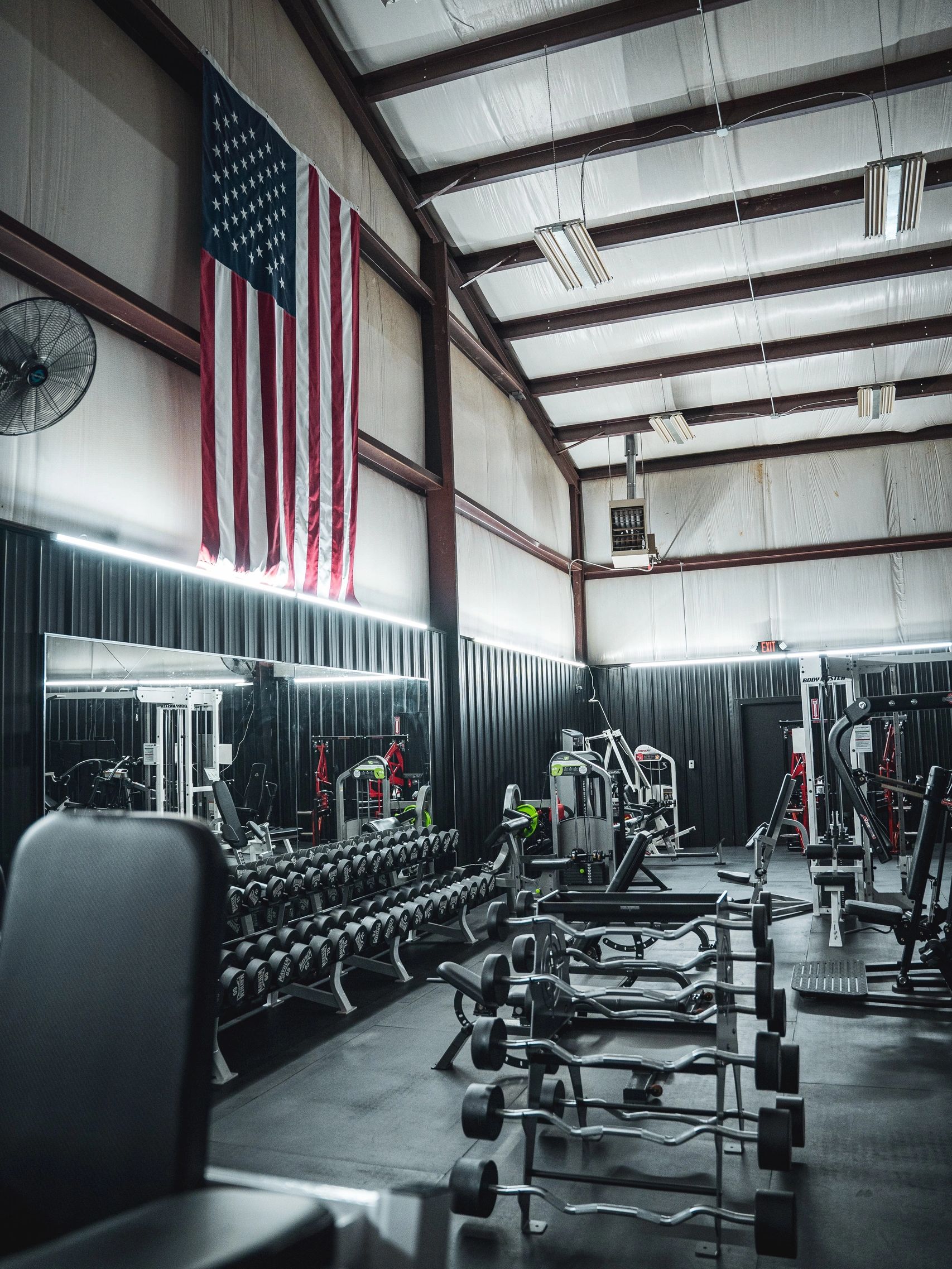 American flag hanging in a gym with exercise equipment. State of the Art equipment.