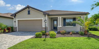 Modern single-story house with a well-maintained lawn and garden.