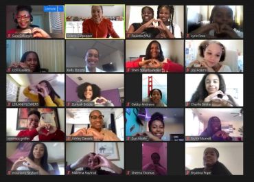 Virtual group forming heart shapes with their hands during a video call.