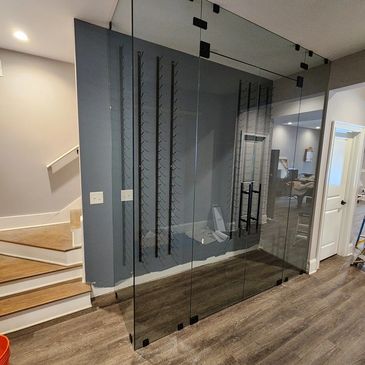 Modern glass-enclosed wine rack in a stylish home interior.