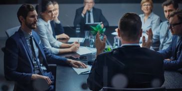 Business team engaged in a serious meeting around a table.
