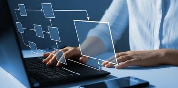 Person interacting with a digital flowchart projected from laptop.