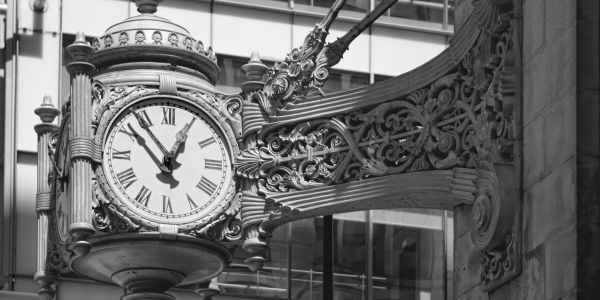 Ornate vintage clock mounted on a building exterior.