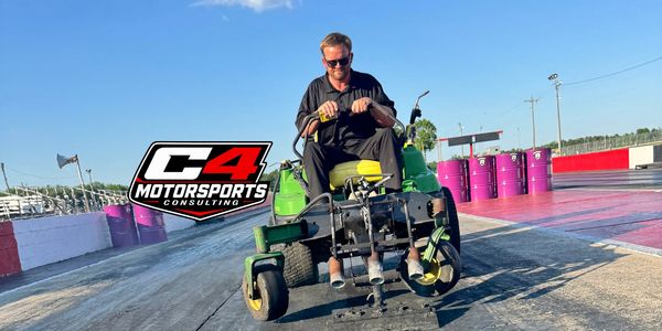Man riding a specialized mower on a racetrack with C4 Motorsports logo.