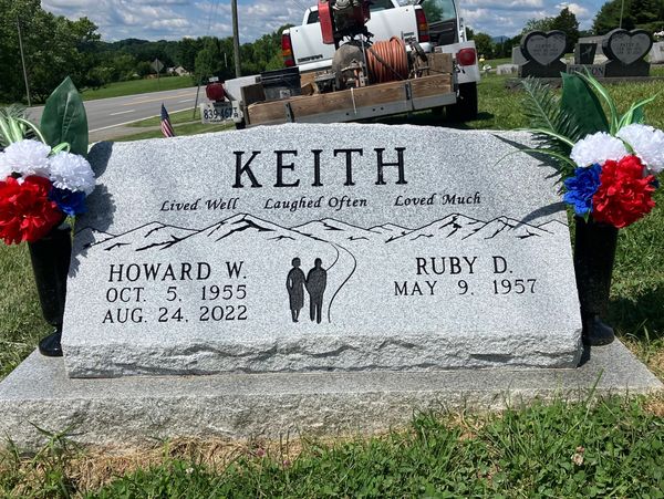 Headstone of Howard W. Keith and Ruby D. Keith with mountains and couple engraving.