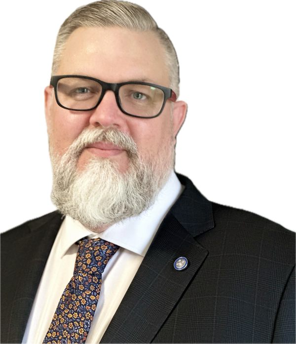 Bearded man in a suit with glasses and a floral tie.
