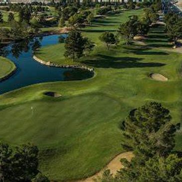 A scenic golf course with water features and lush greenery.