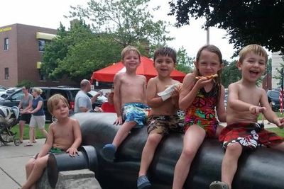 Kids sitting on real civil war cannon  facing Silver Beach in St. Joseph Michigan