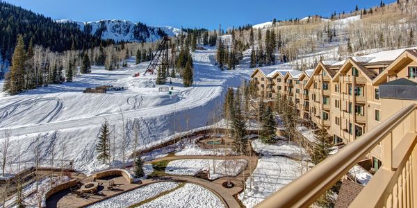 Snow-covered ski resort with mountain views and cozy lodging.