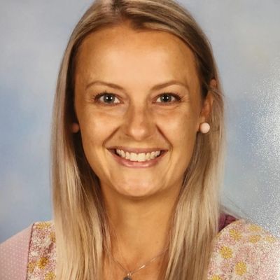 Portrait of a blonde woman smiling.