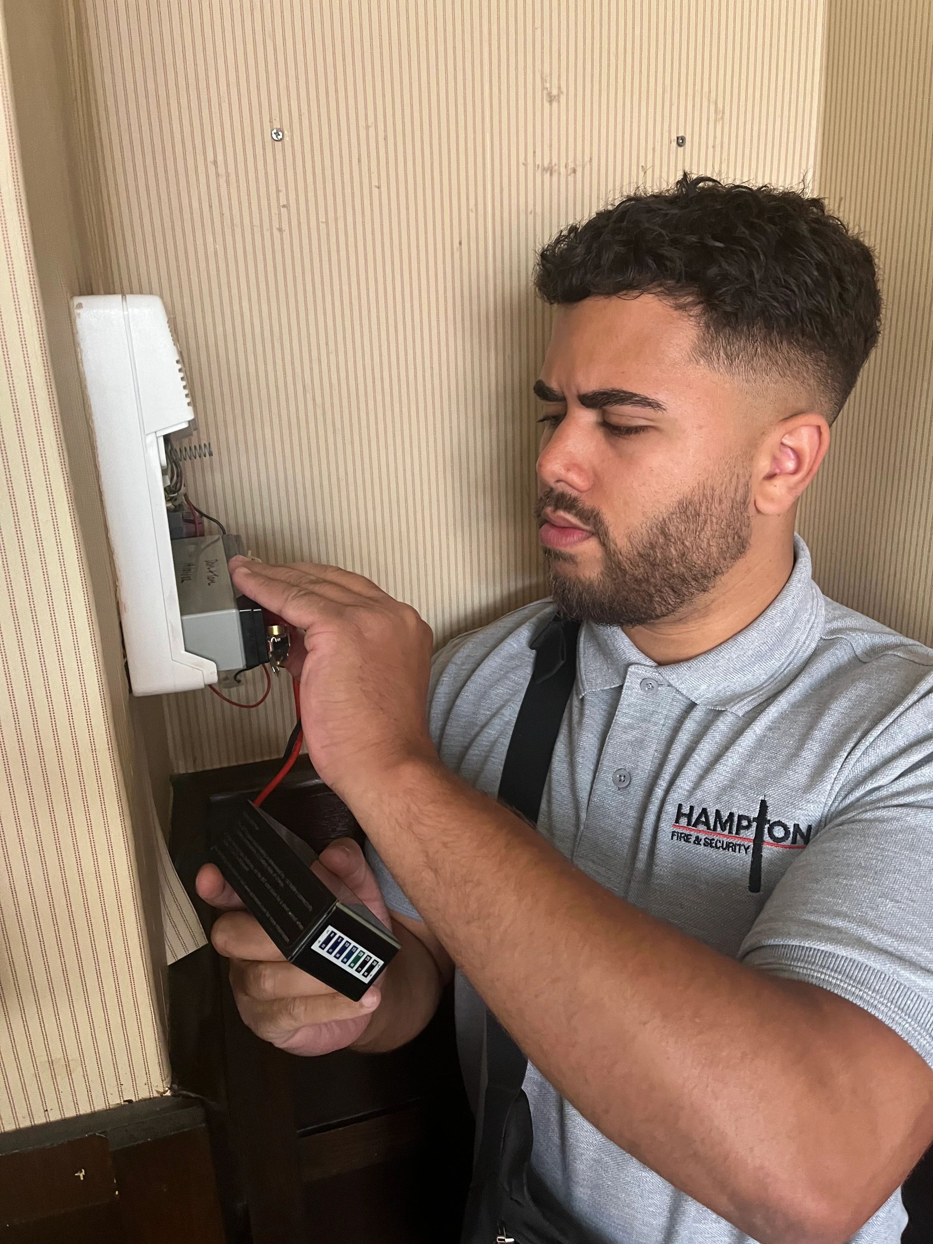 Hampton Security Engineer Servicing an Alarm System