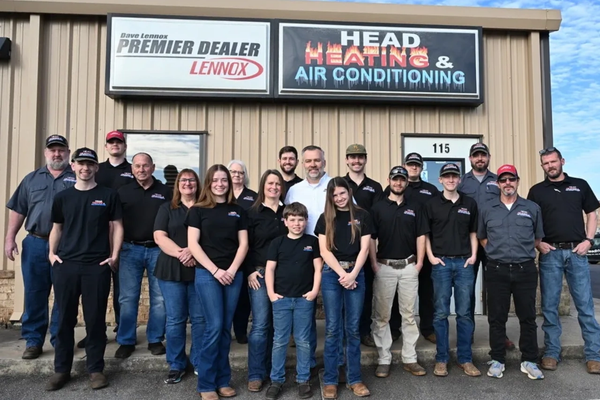 Group photo of HVAC company employees in front of their office.