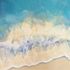 Turquoise water, and wave crashing into the sandy shoreline