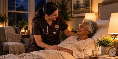 Nurse comforting a senior woman in bed.