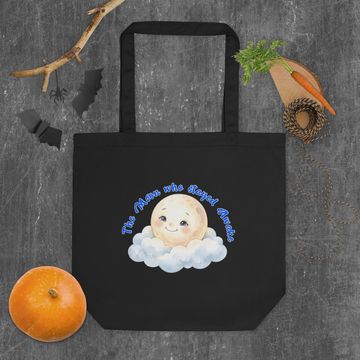 Black tote bag with a cute moon design and text.