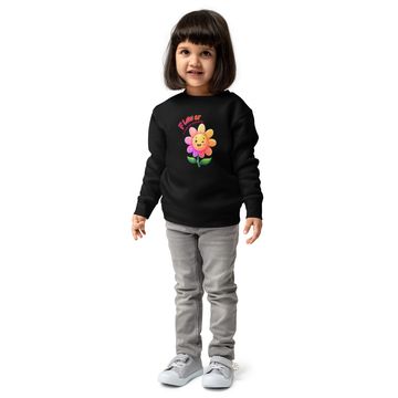 Little girl in a black sweatshirt with a colorful flower design.
