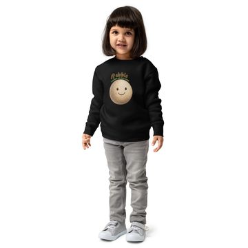 Young girl in black sweatshirt with smiley pebble design.