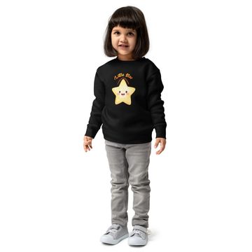 Young girl in black star sweatshirt and gray pants.