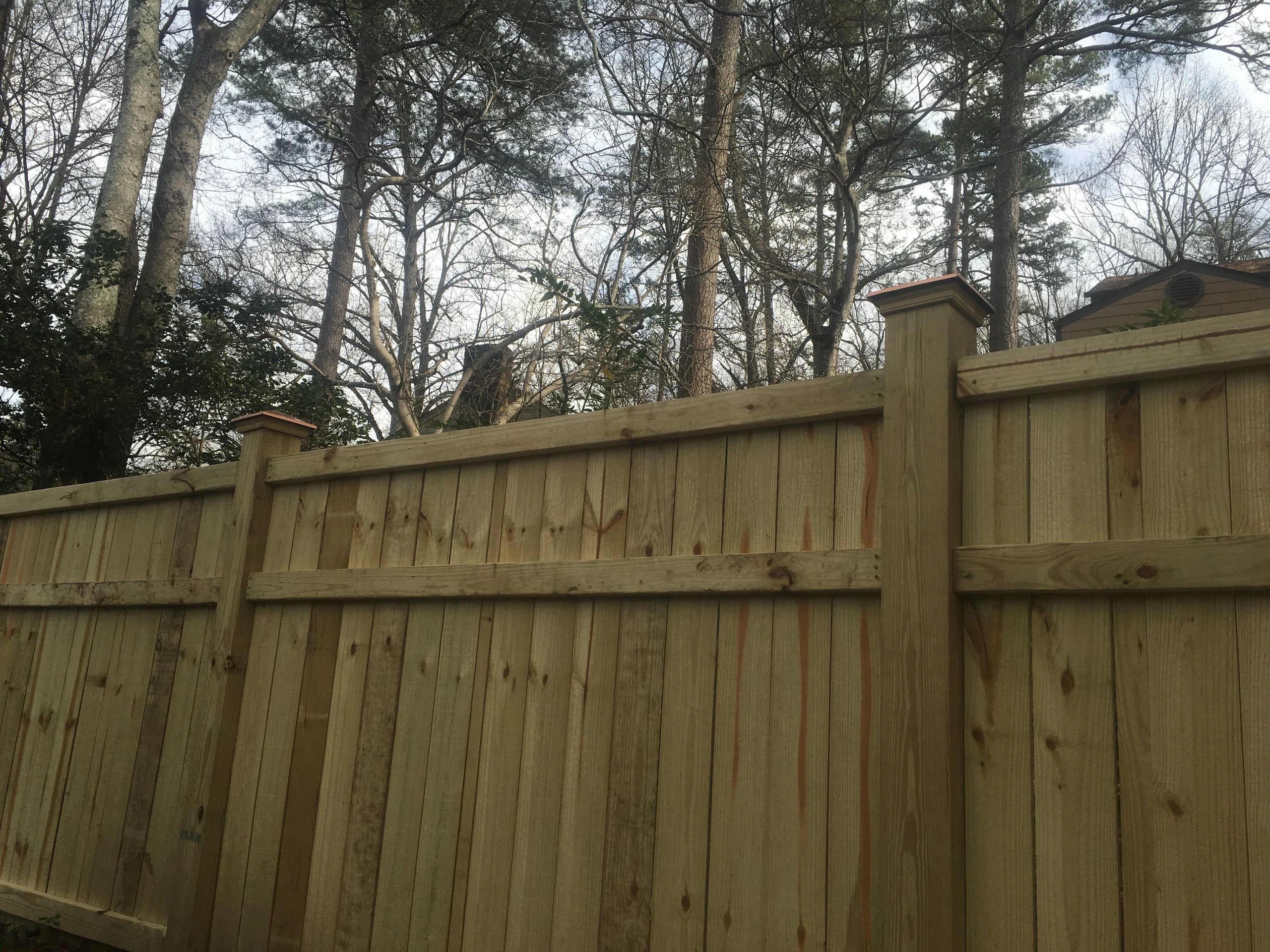 Wooden fence with scenic backdrop.