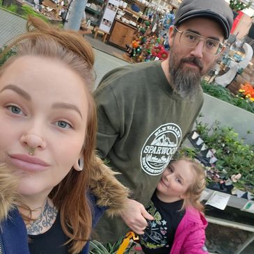 Family outing at a garden center with plants and flowers.