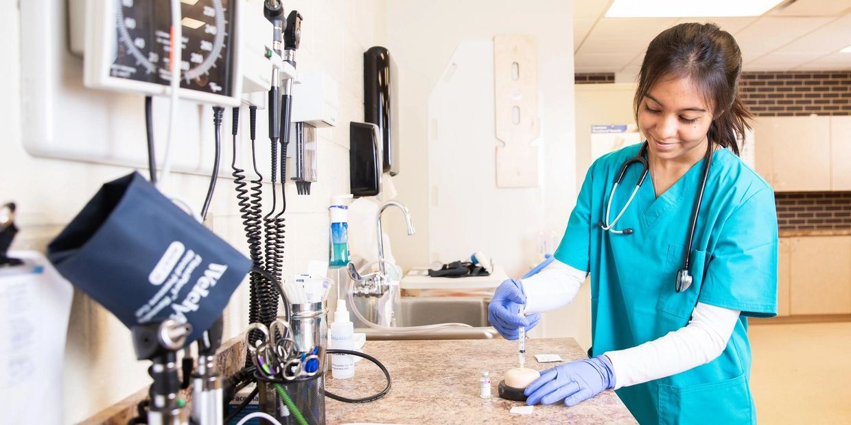 A nurse prepares an injection in a clinical setting.