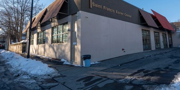 Exterior of the Saint Francis Xavier Center on a clear winter day with snow on the ground.
