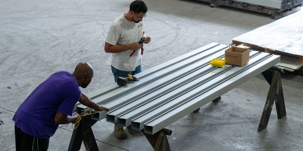 Keith and David working as a team to build custom sheet metal.